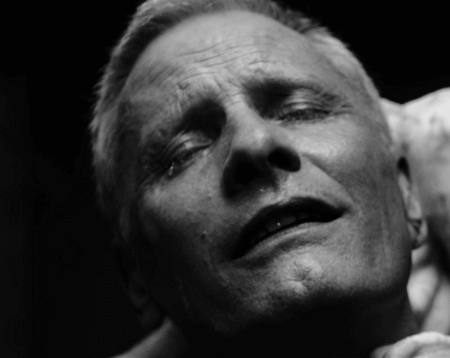 Black-and-white screenshot of Tenser weeping.